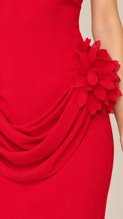 Close up of 3D floral applique and pleated drape on red maxi dress