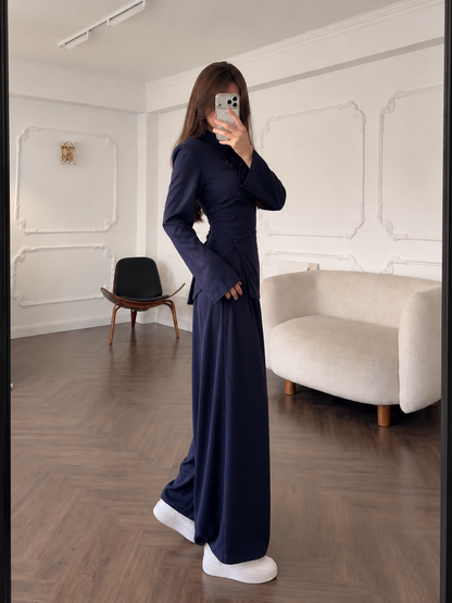 Side view of the navy two-piece outfit with shaped waist and long sleeves