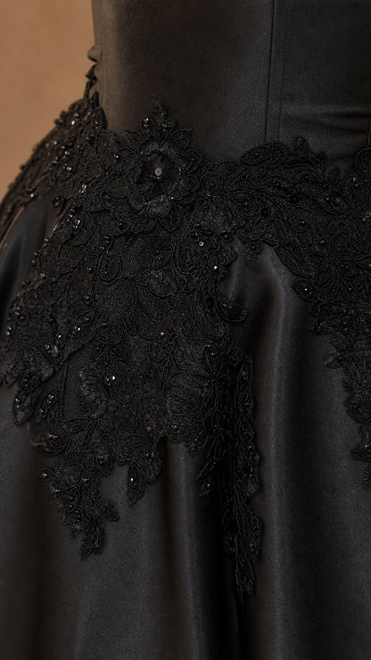 Close-up of beaded floral lace embroidery on satin bodice