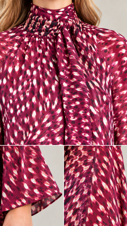Close-up details of the high tie neckline, cuff, and fabric print in magenta