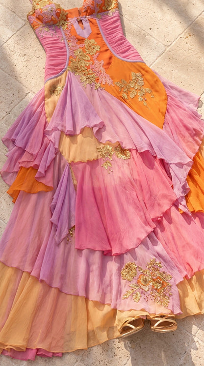 Close-up flat lay detail of Sunset Multi tiered chiffon dress with gold floral embroidery