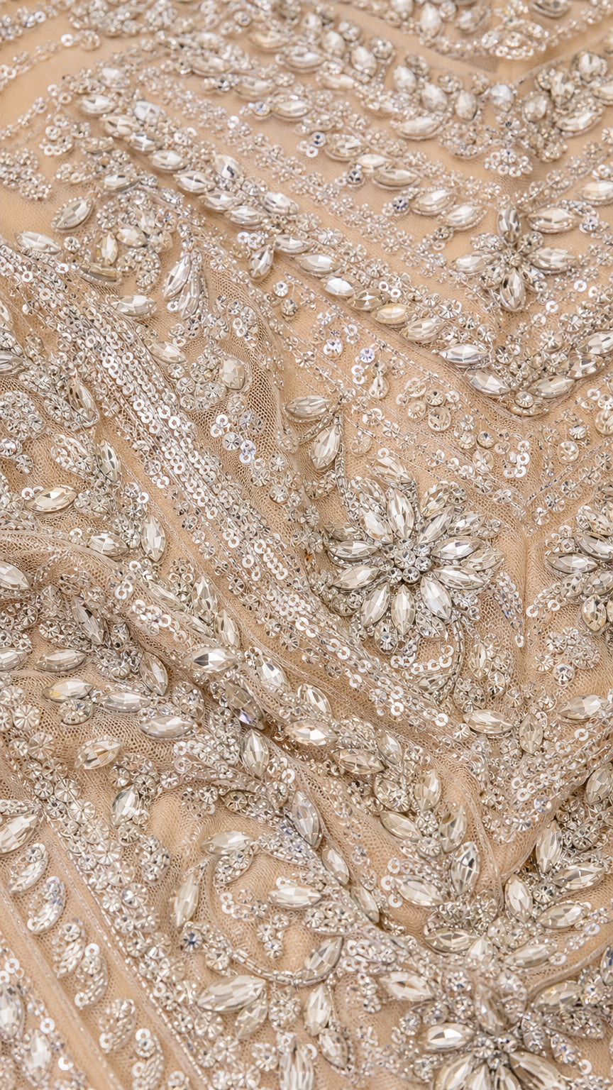 Close-up detail of intricate crystal, bead, and sequin floral embroidery