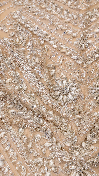 Close-up detail of intricate crystal, bead, and sequin floral embroidery