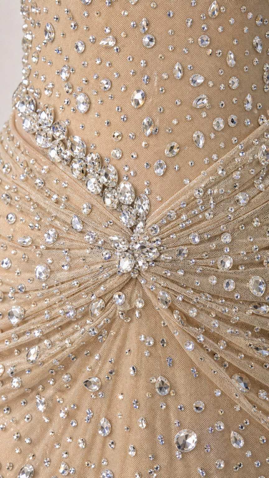 Close-up detail of intricate rhinestone cluster and gathered fabric on waist