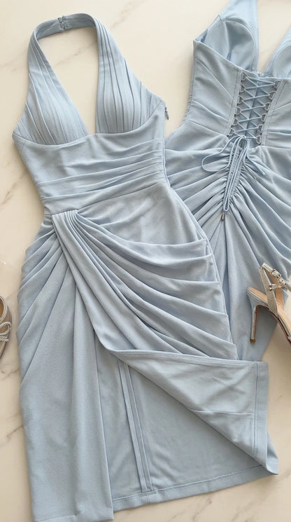 Flat lay close-up of light blue halter gown highlighting pleated bust and ruched texture