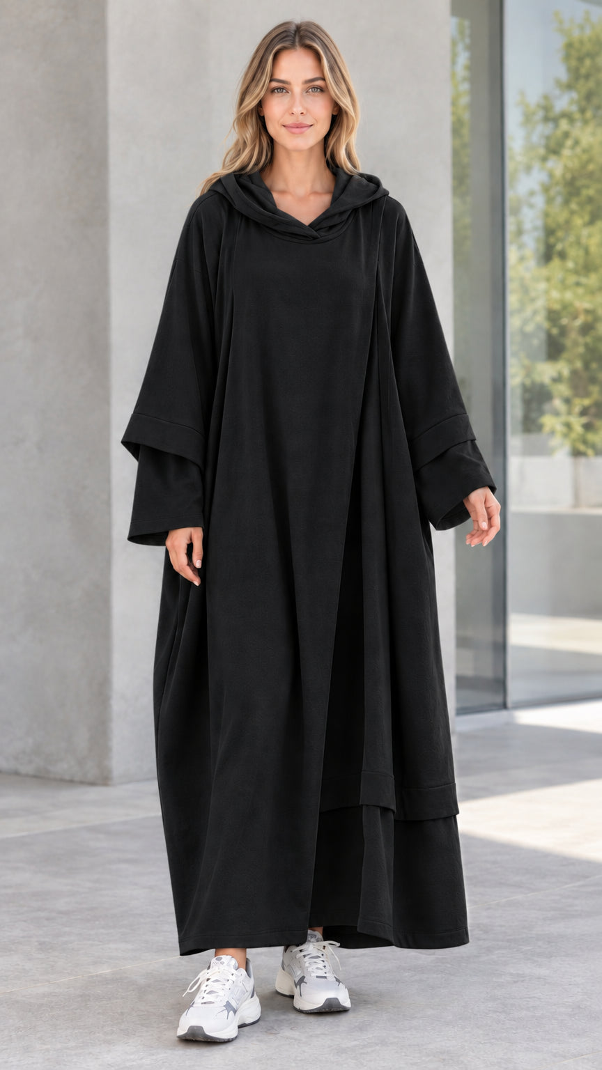 Front view of woman wearing black oversized hooded maxi dress