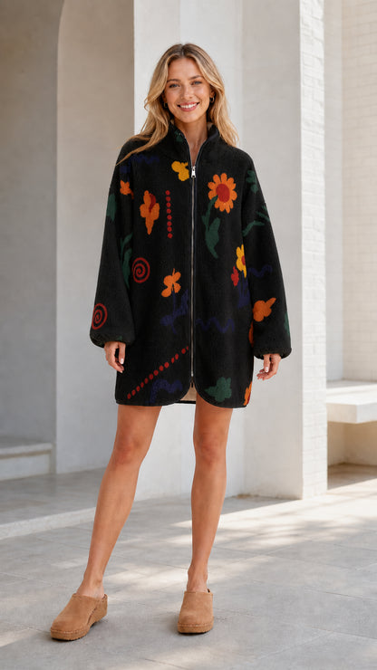 Front view of a black women's floral printed fleece zip-up jacket