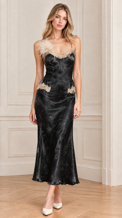 Front full-length view of woman wearing black satin jacquard slip dress with lace trim