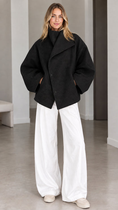 Model wearing classic black asymmetrical high neck short jacket