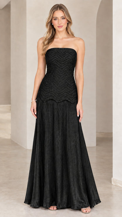 Full-length view of model in black strapless beaded evening maxi gown