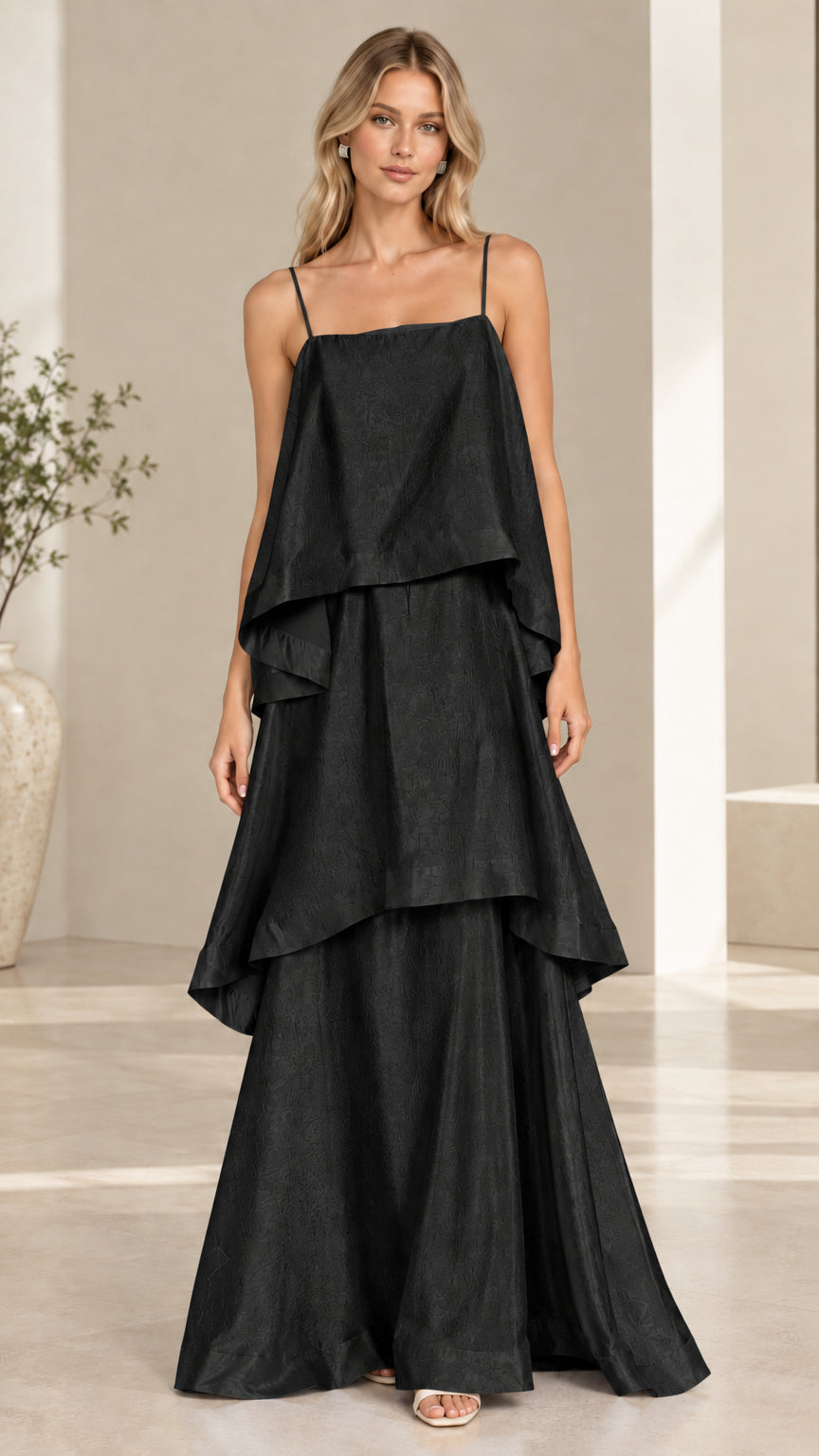 Model wearing black tiered cami maxi dress front view