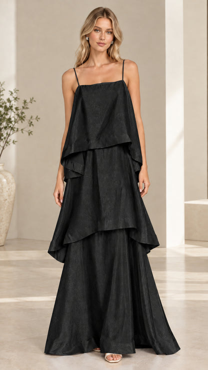 Model wearing black tiered cami maxi dress front view