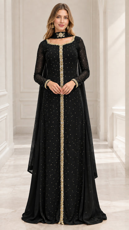 Model wearing black long sleeve embellished maxi evening gown with cape drape