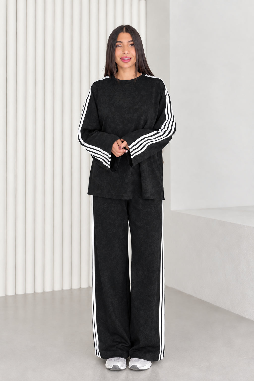 Full length view of model wearing black two-piece striped lounge set
