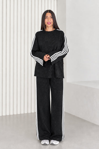 Full length view of model wearing black two-piece striped lounge set