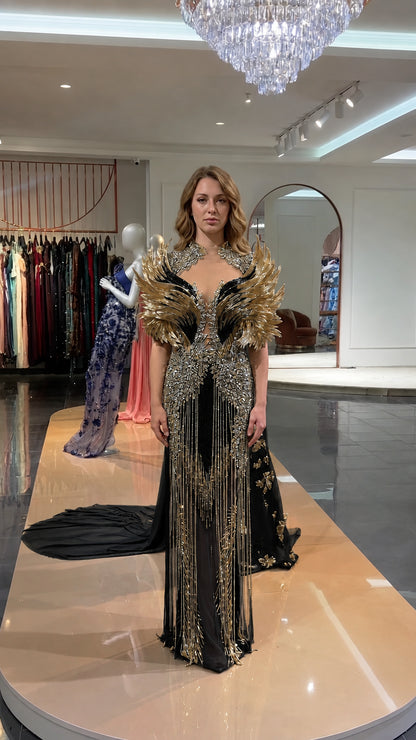 Front view of black and gold embellished feather shoulder evening gown