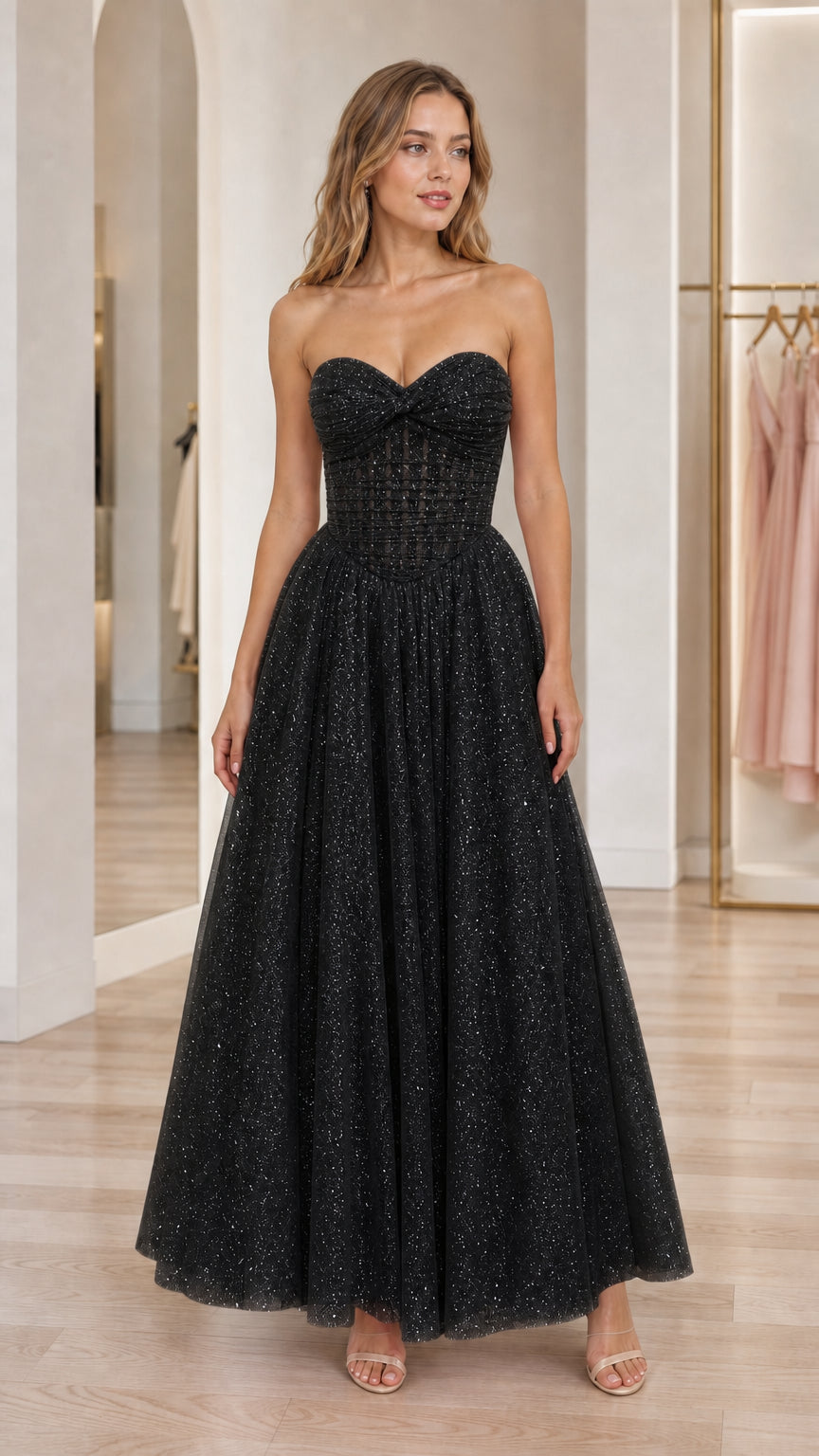 Front view of black strapless glitter tulle evening gown