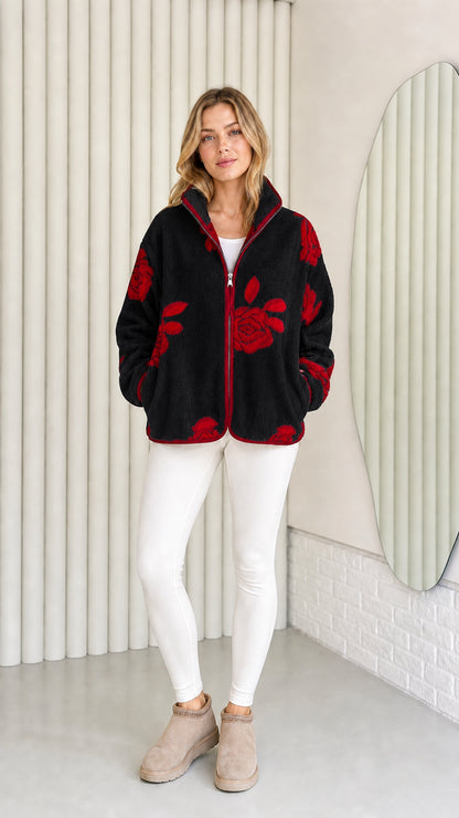 Model wearing black fleece jacket with red floral pattern