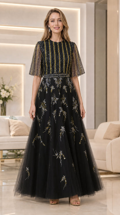 Model wearing black beaded flutter-sleeve tulle evening gown