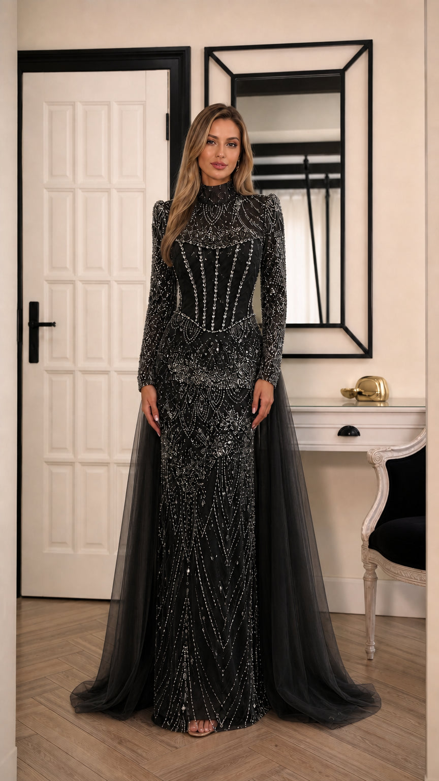 Model wearing black high neck beaded long sleeve evening gown with tulle train