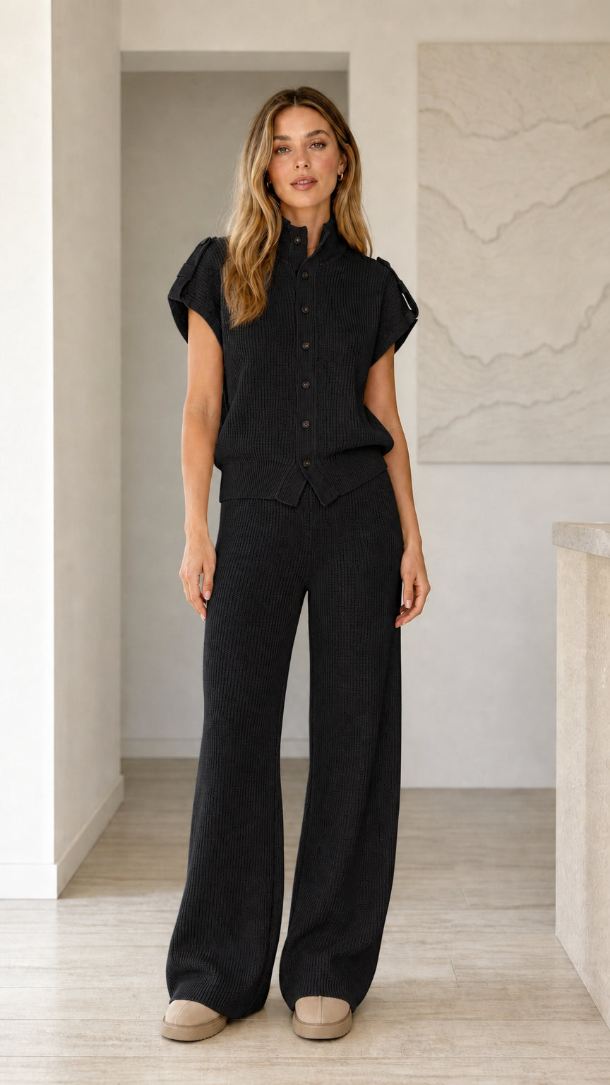 Front view of model wearing black ribbed knit button top and wide leg pants set