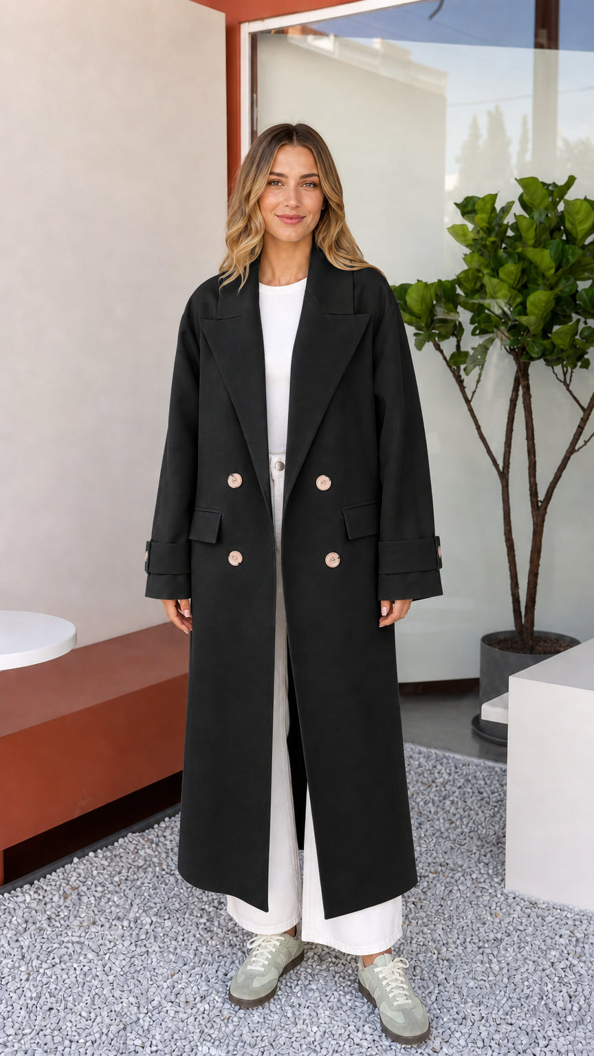 Front view of woman wearing classic Black double-breasted maxi coat