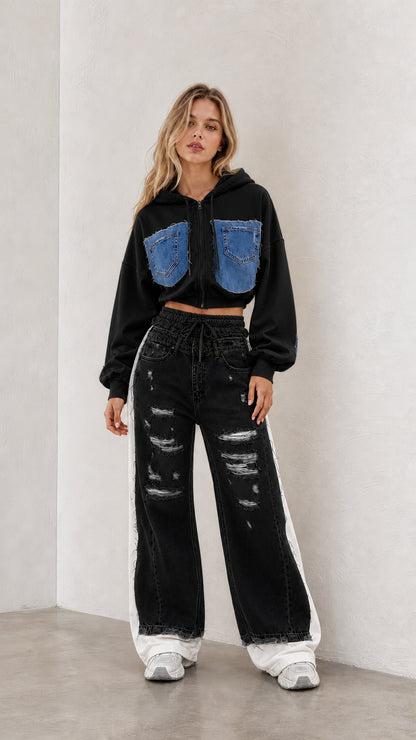 Model wearing black cropped zip hoodie and black distressed wide leg pants set