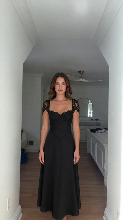 Model wearing black lace cap-sleeve corset bodice maxi dress