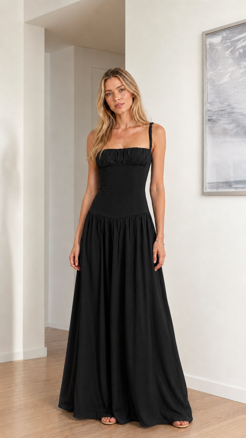 Model wearing classic black ruched drop waist evening maxi dress
