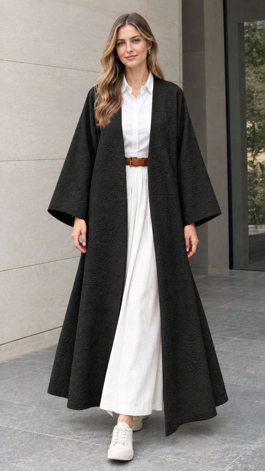 Front full-length view of woman wearing black textured jacquard open-front maxi duster