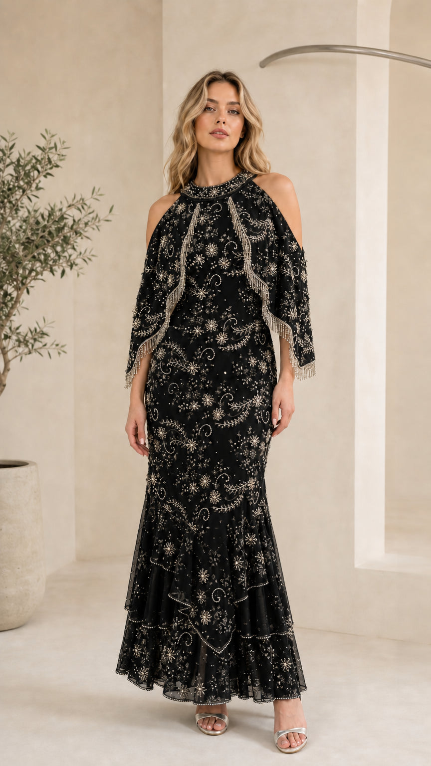 Black cold-shoulder beaded capelet mermaid evening gown on model