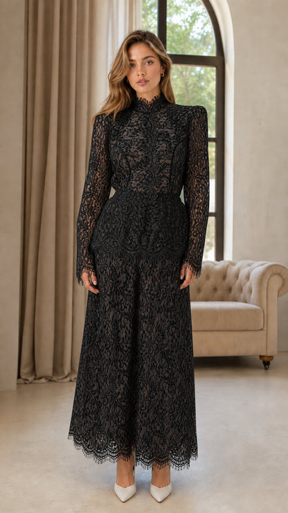Front full view of woman wearing black floral lace mock neck wide leg jumpsuit