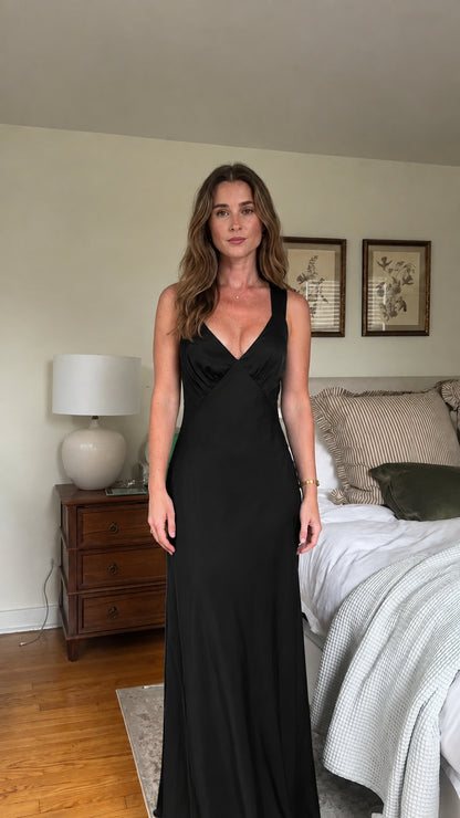 Front view of black satin V-neck maxi dress on model