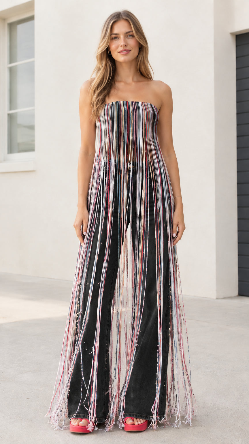 Model wearing multicolor black striped maxi fringe strapless tube top with black wide-leg jeans