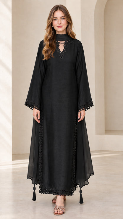 Front view of model wearing black embroidered long sleeve maxi kaftan dress