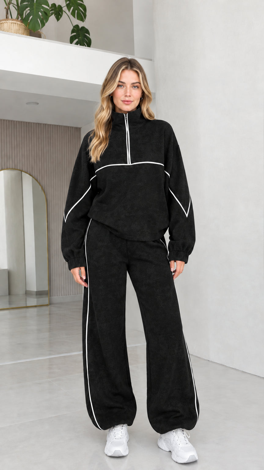 Black women's two-piece quarter zip fleece tracksuit set