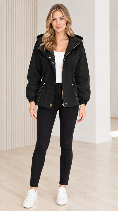 Front view of model wearing black hooded drawstring utility jacket