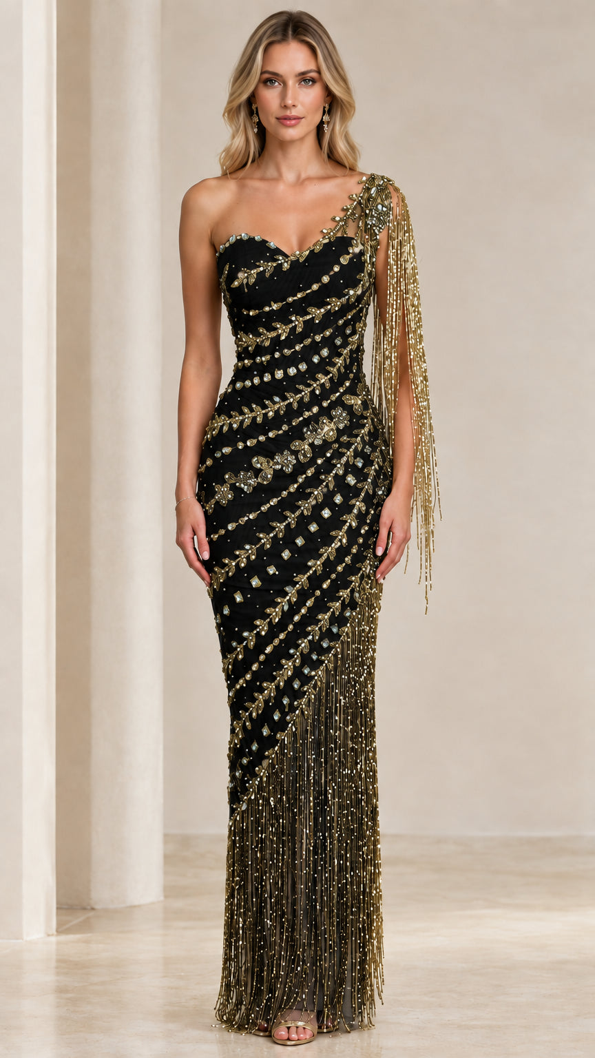 Front view of model wearing Black and gold one-shoulder beaded fringe evening gown