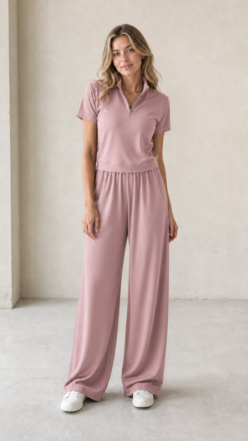 Front view of woman wearing dusty pink half-zip short-sleeve top and wide-leg pants set