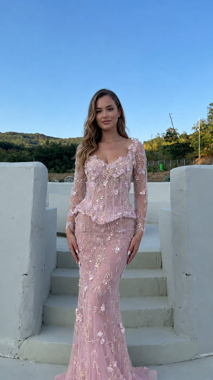 Model wearing the floral appliqué corset peplum evening gown in blush pink