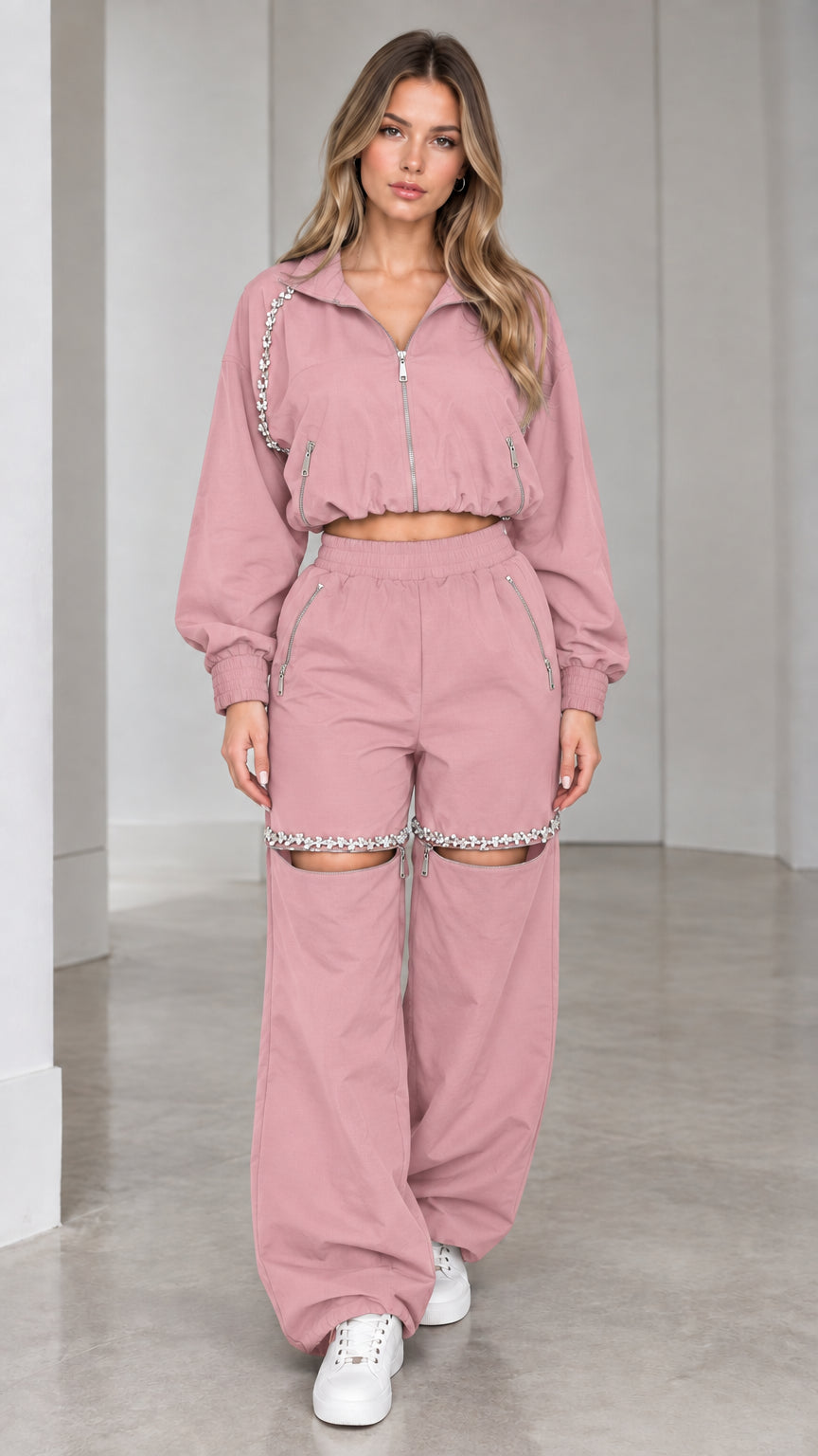 Model wearing dusty pink cropped zip jacket and rhinestone cut-out wide leg pants set