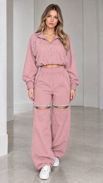 Model wearing dusty pink cropped zip jacket and rhinestone cut-out wide leg pants set