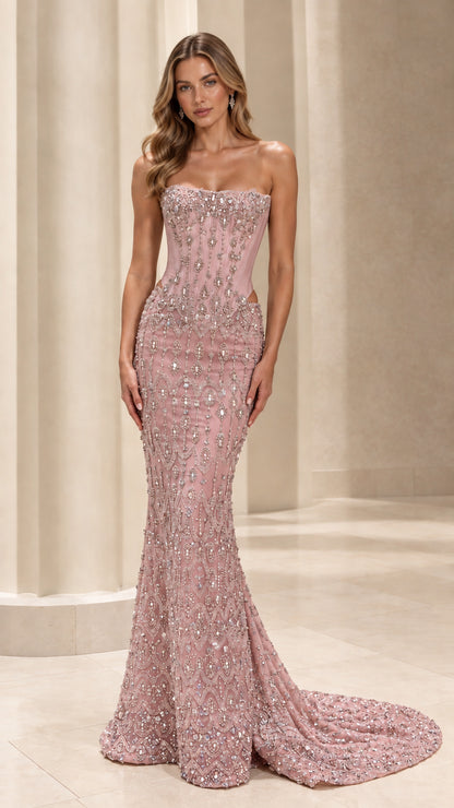 Model wearing blush pink strapless beaded corset mermaid gown with train