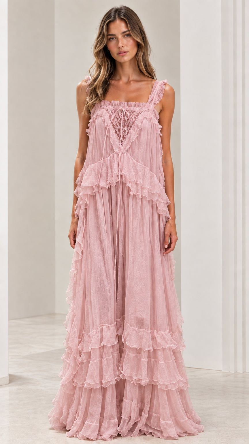 Front view of woman wearing dusty pink tiered ruffled maxi dress