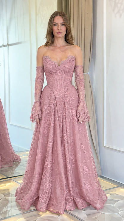 Front view of model wearing dusty pink lace corset evening gown with matching sleeves