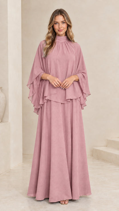 Model wearing dusty pink mock neck cape overlay maxi dress