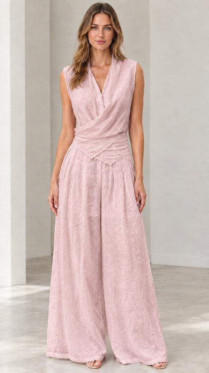 Front view of woman wearing blush pink sleeveless draped wide-leg jumpsuit