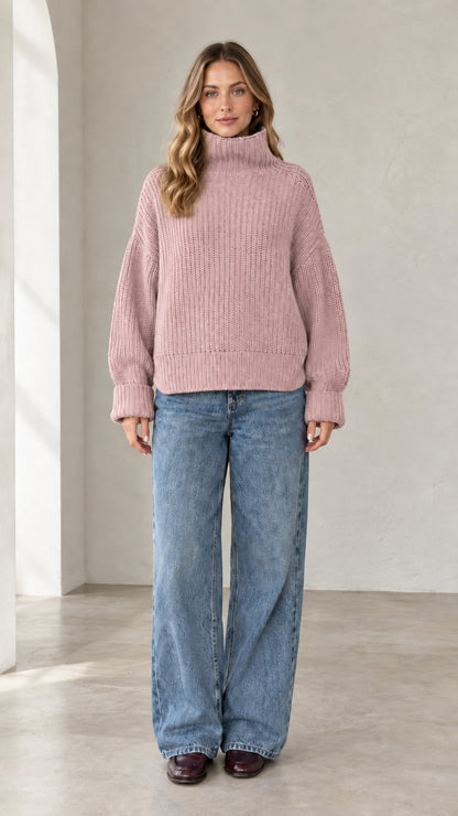 Model wearing dusty pink chunky ribbed high neck knit sweater