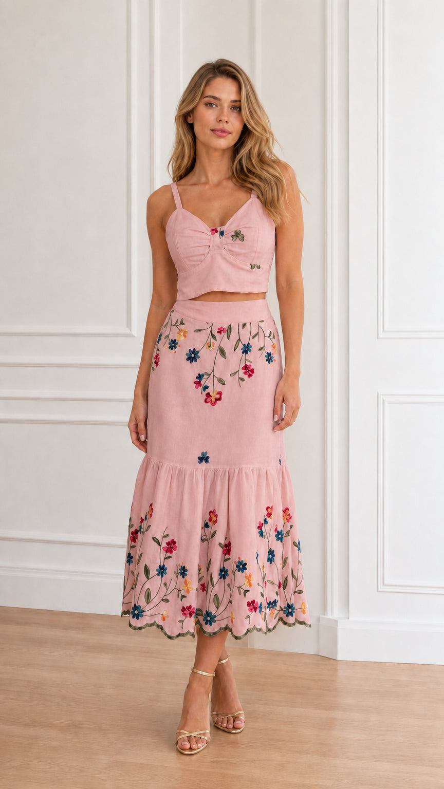 Model wearing dusty pink floral embroidered crop top and tiered midi skirt set