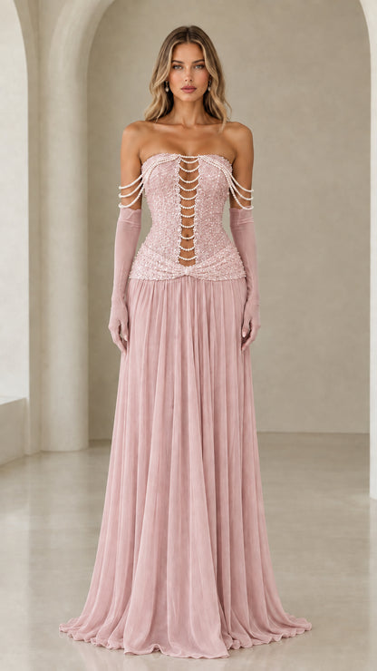 Model wearing pink strapless pearl beaded corset maxi dress with matching gloves